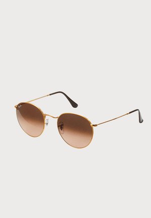 Gold metal sunglasses with round frames, gradient brown lenses, and black-accented arms. Lightweight design with a minimalist aesthetic.