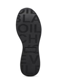 Semelle de chaussure en caoutchouc noir avec des lignes horizontales surélevées et le logo "VOILE BLANCHE" en relief. Présente une surface lisse avec un texte à motifs.