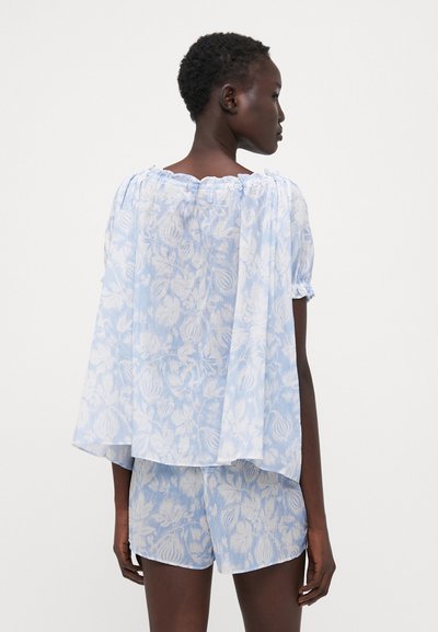 Lightweight, sheer blue floral top with a gathered neckline and short puff sleeves, paired with matching floral shorts. Soft, textured fabric.