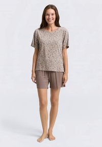 Brown leopard print short-sleeve top with matching solid brown shorts, made of soft fabric. Relaxed fit, perfect for casual wear.