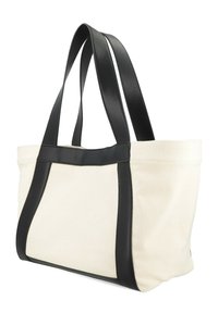 Sac en toile crème avec des accents en cuir noir. Dispose de deux poignées robustes et d'un design structuré élégant avec des couleurs contrastées.