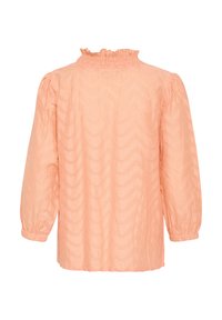 Blouse couleur pêche avec un col smocké, des manches bouffantes longues et un motif en zigzag texturé. Tissu léger avec une coupe décontractée.