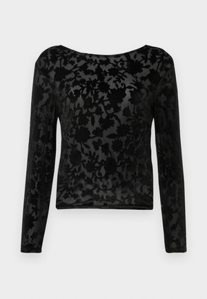 Top nero a maniche lunghe realizzato in tessuto trasparente con un motivo floreale. Collo rotondo e forma aderente, con una leggera texture in tutto il capo.