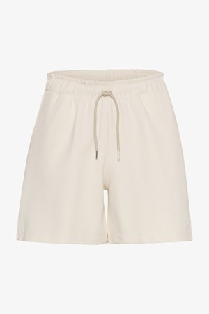 Crème-kleurige shorts gemaakt van zachte stof, met een elastische tailleband met een trekkoord en metalen uiteinden. Eenvoudig ontwerp zonder patronen.