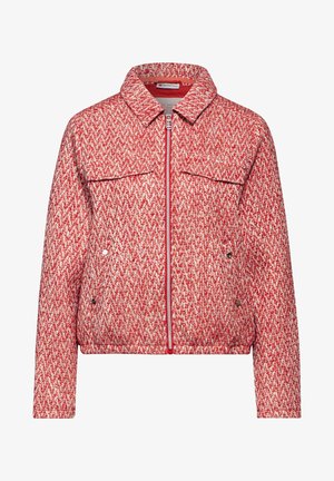 Red and white patterned cropped jacket with a zip front, buttoned chest pockets, and a collared neckline. Soft textured fabric.