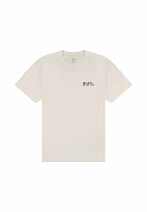 Kremowy bawełniany t-shirt z krótkimi rękawami i okrągłym dekoltem. Na piersi znajduje się granatowy napis "WORKWEAR IS FOR SOUL".