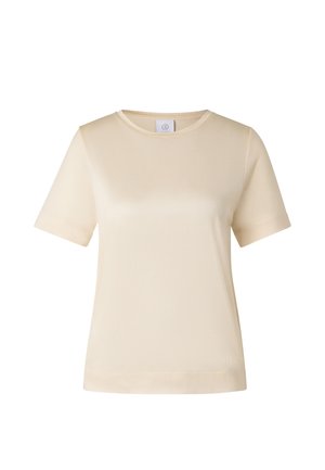 T-shirt crème à manches courtes avec col rond, en tissu simple et lisse, comportant une petite étiquette de marque à l'intérieur de l'encolure.