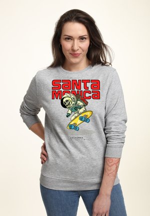 Grijze sweatshirt met een grafisch ontwerp van een skelet in een ruimtepak op een skateboard, met "SANTA MONICA" in vetrode letters.