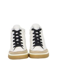 White high-top sneakers with black laces, beige toe caps, side zipper, and gum rubber soles, shown from the front on a white background.