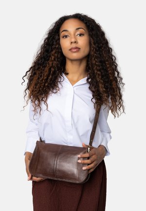 Borsa a tracolla in pelle marrone con una texture liscia, forma curva e tracolla staccabile. Caratterizzata da accessori in argento e dettagli di cucitura minimi.