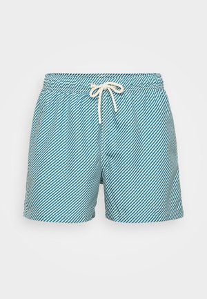 Gai zilā peldbikses ar baltām diagonālām svītrām, elastīgu jostasvīru un regulējamu saiti. Mīksta auduma, ar brīvu piegriezumu.