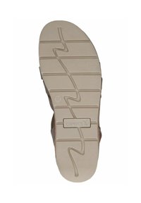 Sole di sandali marrone chiaro con un motivo testurizzato caratterizzato da scanalature a zigzag. Logo "CAPRICE" stampato sul lato, taglia segnata come 37.