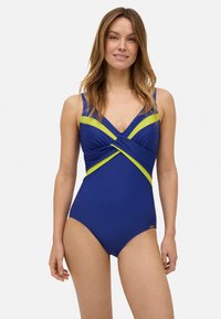 Bañador de una sola pieza en color azul con detalles en verde lima, que presenta un diseño cruzado en el busto y una textura suave.