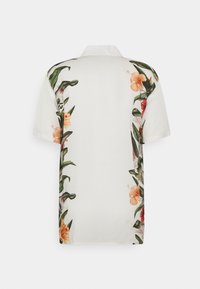 Short-sleeved shirt in white fabric, featuring floral patterns in shades of orange and green along the sides and back.