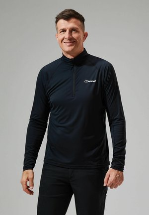 Schwarzes, figurbetontes Langarm-Performance-Oberteil mit einem Viertelreißverschlusskragen und Logo auf der Brust. Hergestellt aus leichtem, glattem Material.