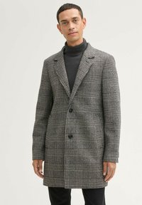 Grau-schwarzer kariert Wollmischmantel mit Reverskragen, zwei Knöpfen und seitlichen Taschen. Glatte Textur mit strukturiertem Schnitt.