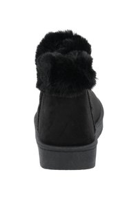 Czarne botki za kostkę z kołnierzem z sztucznego futra, wykonane z miękkiego materiału przypominającego zamsz, mają płaską gumową podeszwę i gładką fakturę. Widok z tyłu pokazuje szczegóły kołnierza.