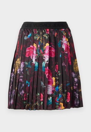 Plisseret skjørt med svart midjebånd som har "VERSACE JEANS" tekst. Stoffet er dekorert med fargerike blomster- og sommerfugl mønstre på en mørk bakgrunn.