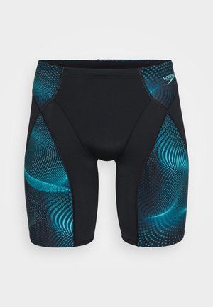 Shorts de bain noirs avec des motifs de vagues et de points turquoise sur les côtés. Tissu lisse et extensible conçu pour le confort et la performance.