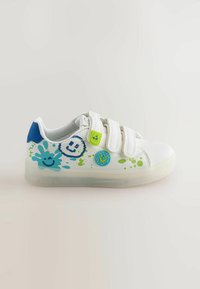White children's sneaker with three velcro straps, blue heel accent, and colorful smiley face and paint splatter designs on side.