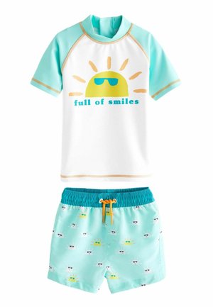 SUNSAFE SET - REGULAR FIT - Pantaloni de trening - green white smiles