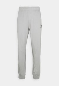 Ljusgrå joggingbyxor med elastisk midja och muddar, med en liten svart logotyp på övre vänstra benet.