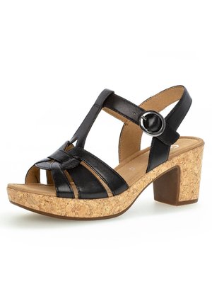 Zwarte leren sandaal met een blokhak van kurk, voorzien van gekruiste bandjes, een enkelriem met een ronde gesp, en een gestructureerd oppervlak.