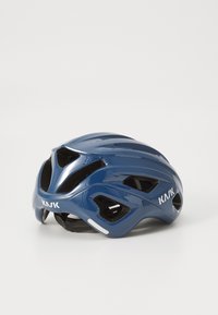 KASK cycling helmet in glossy navy with aerodynamic shape, ventilation holes, and adjustable straps. White logo on the side.
