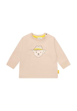 Beige langærmet baby-skjorte med et syet bamseansigt iført en gul og beige hat på brystet og en trykknap på kraven.