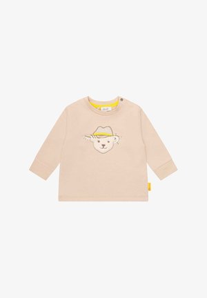 Beige langærmet baby-skjorte med et syet bamseansigt iført en gul og beige hat på brystet og en trykknap på kraven.