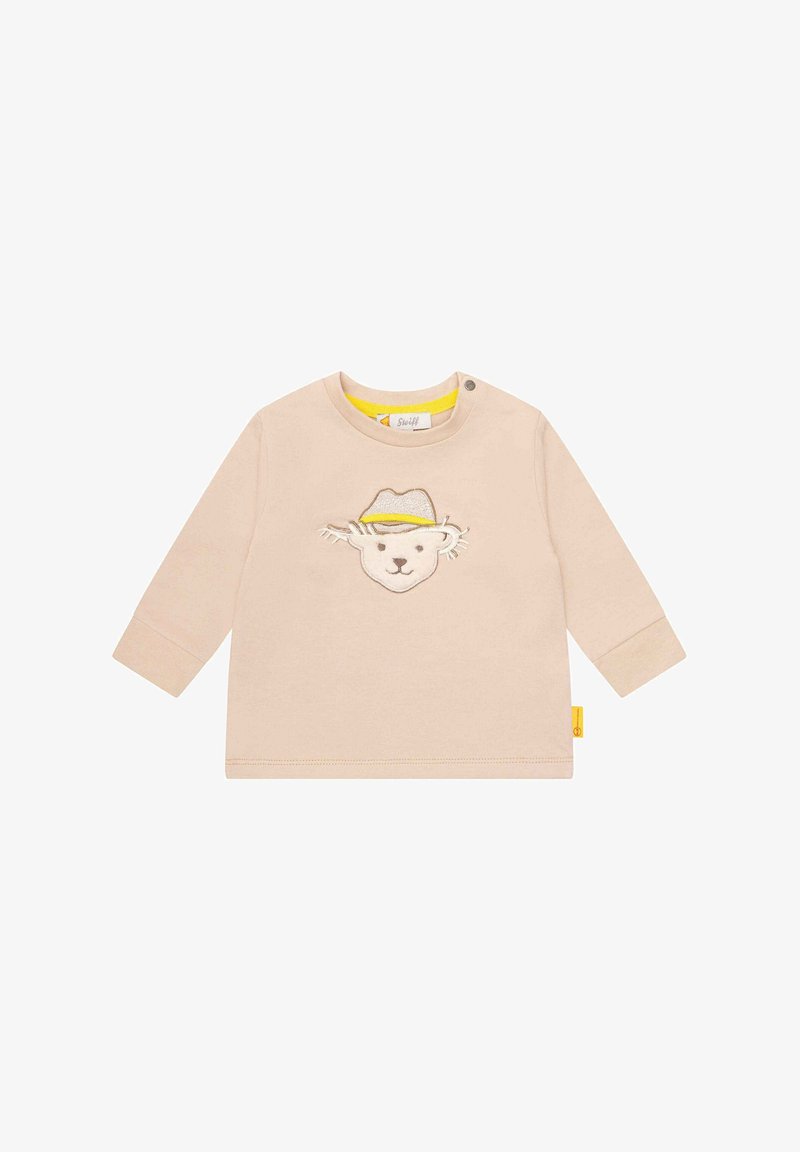 Chemise bébé à manches longues beige avec un visage d'ours brodé portant un chapeau jaune et beige sur la poitrine et une pression au col.