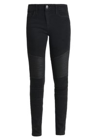 Černé dámské skinny džíny z denimového materiálu s hladkou texturou, které mají šité žebrované panely na kolenou a klasický pětikapsový design.