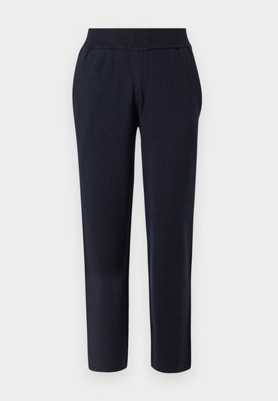 Mørkeblå, tapered bukser med en blød tekstur, elastisk talje og uden synlige lommer, designet for komfort og alsidighed.