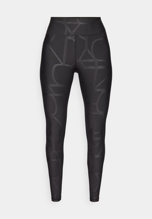 Leggings noirs avec un motif géométrique subtil, une taille haute et une texture lisse et extensible pour le confort et le mouvement.