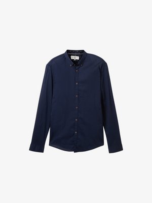 Navy blue long-sleeve shirt with button-down collar, brown buttons, and patterned inner lining featuring stars. Smooth fabric texture.