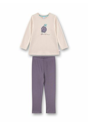 Langärmliges cremefarbiges Oberteil mit einem Grafikdruck eines Cartoon-Charakters, kombiniert mit lila Leggings. Beide Teile sind aus weichem Baumwollstoff.