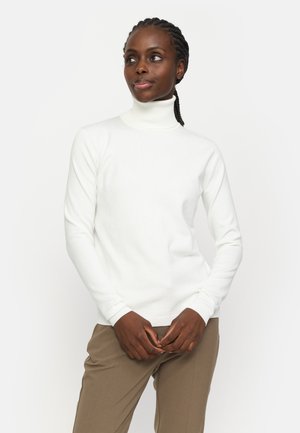 White turtleneck sweater with ribbed texture and fitted silhouette, paired with beige trousers. Sweater features long sleeves and a snug collar.