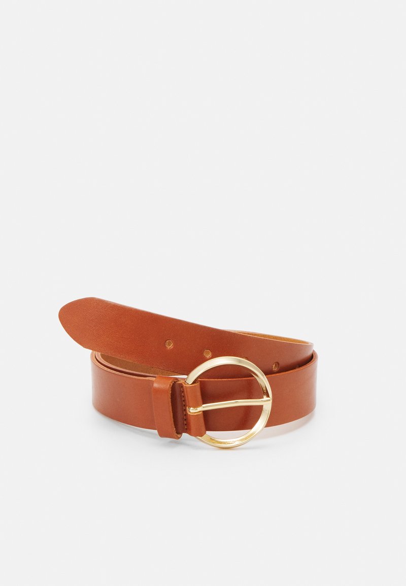 Tan leather belt with a smooth texture, featuring a large round gold buckle and multiple adjustment holes for sizing.