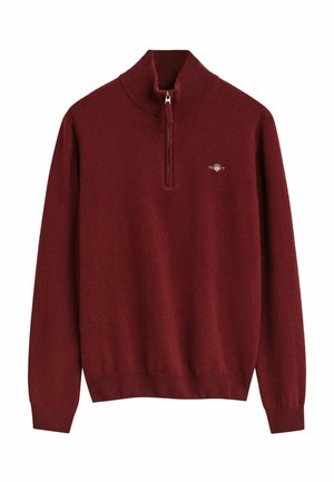 Burgunderfarbener Zip-Pullover aus weichem Strickmaterial, mit einem gerippten Saum und Bündchen sowie einem kleinen gestickten Logo auf der Brust.