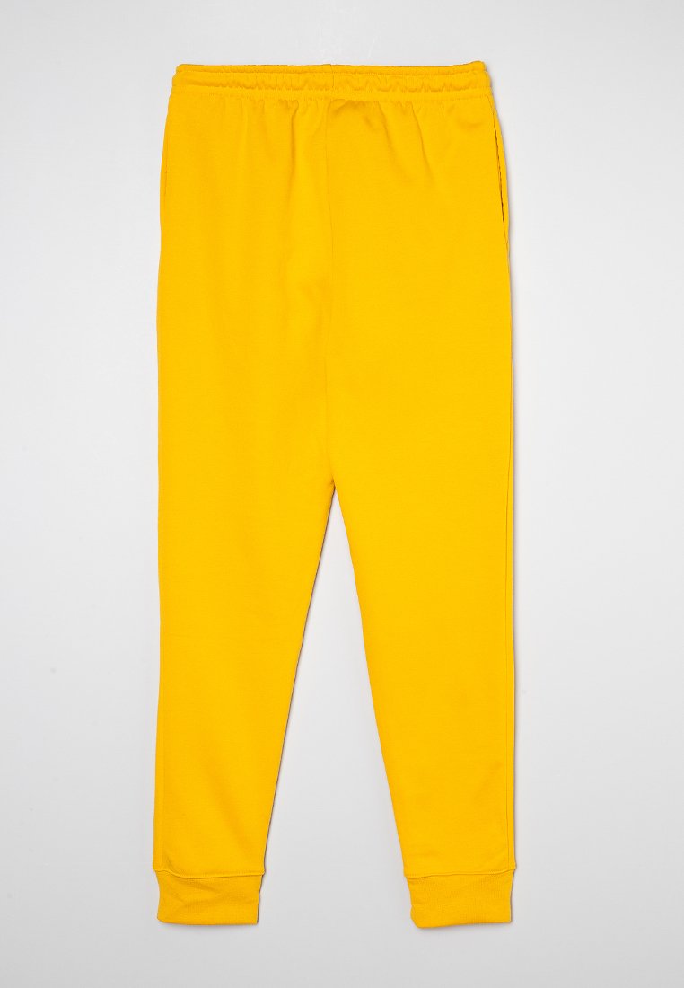 Gelbe Jogginghose mit elastischem Bund, schmal zulaufenden Beinen und gerippten Bündchen. Hergestellt aus weichem, glattem Stoff ohne sichtbare Muster oder Akzente.