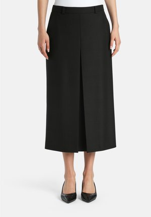 Black midi skirt with a straight cut, featuring a front pleat and waistband. Fabric has a smooth texture, paired with pointed black heels.