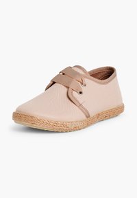 Scarpa in tela beige con lacci elastici, punta arrotondata e suola in juta intrecciata. Texture liscia con dettagli di cucitura delicati.