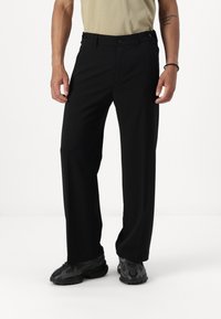 Zwarte op maat gemaakte broek met een recht pijpdesign, voorzien van twee voorkanten zakken, een vlakke voorkant en een gladde stoftextuur.