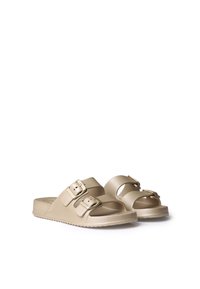 Beige slide sandals with two adjustable buckles, textured straps, and a contoured footbed. Flat sole with grip detailing.
