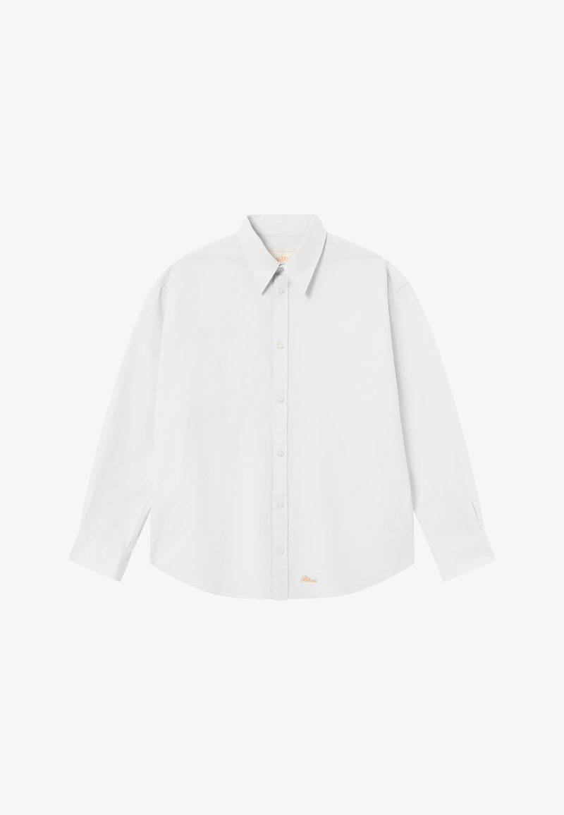 White button-up shirt with a classic collar, long sleeves, and a rounded hem; features small orange logo at the bottom left side.