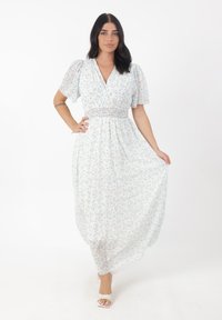 Fliederfarbenes Maxikleid mit kurzen Puffärmeln, tiefem V-Ausschnitt, elastischem Taillenteil und einem fließenden Rockmuster aus kleinen Blumen.