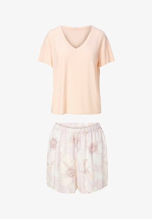 Top de manga corta y escote en V de color melocotón suave combinado con shorts de cintura elástica y estampado floral en rosa pálido.