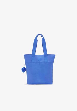 Blue fabric tote bag with two top handles, a round logo detail, and a small blue pom-pom charm attached to the side. Smooth texture.