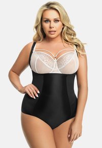 Schwarze shapewear mit durchsichtigen weißen Spitzenverzierungen, Unterwäschestütze und verstellbaren Trägern. Verfügt über eine glatte Oberfläche mit Seitennähten.