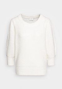 Pull en tricot blanc avec un col rond, des manches bouffantes, et des poignets et un ourlet côtelés. Motif texturé sur tout le tissu.